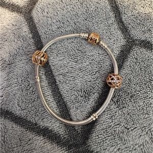 Silver Pandora bracelet with three rose gold charms